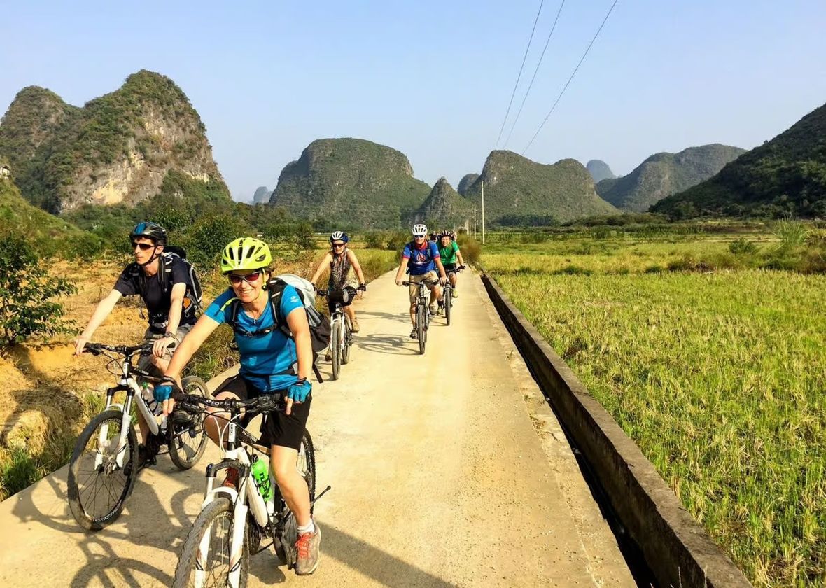 Group of cyclists with karsts in the background