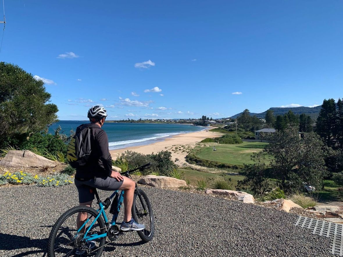 Cyclist looking out over beach