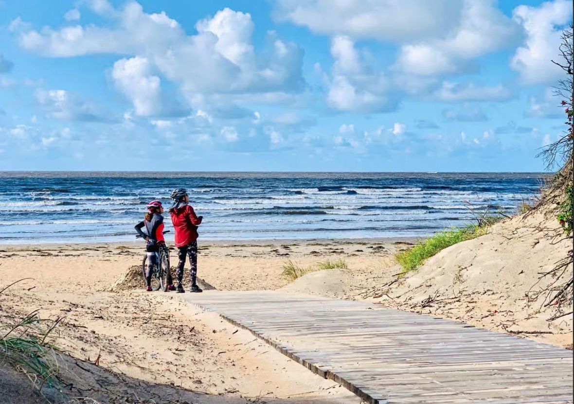 Couple of cyclists on beach