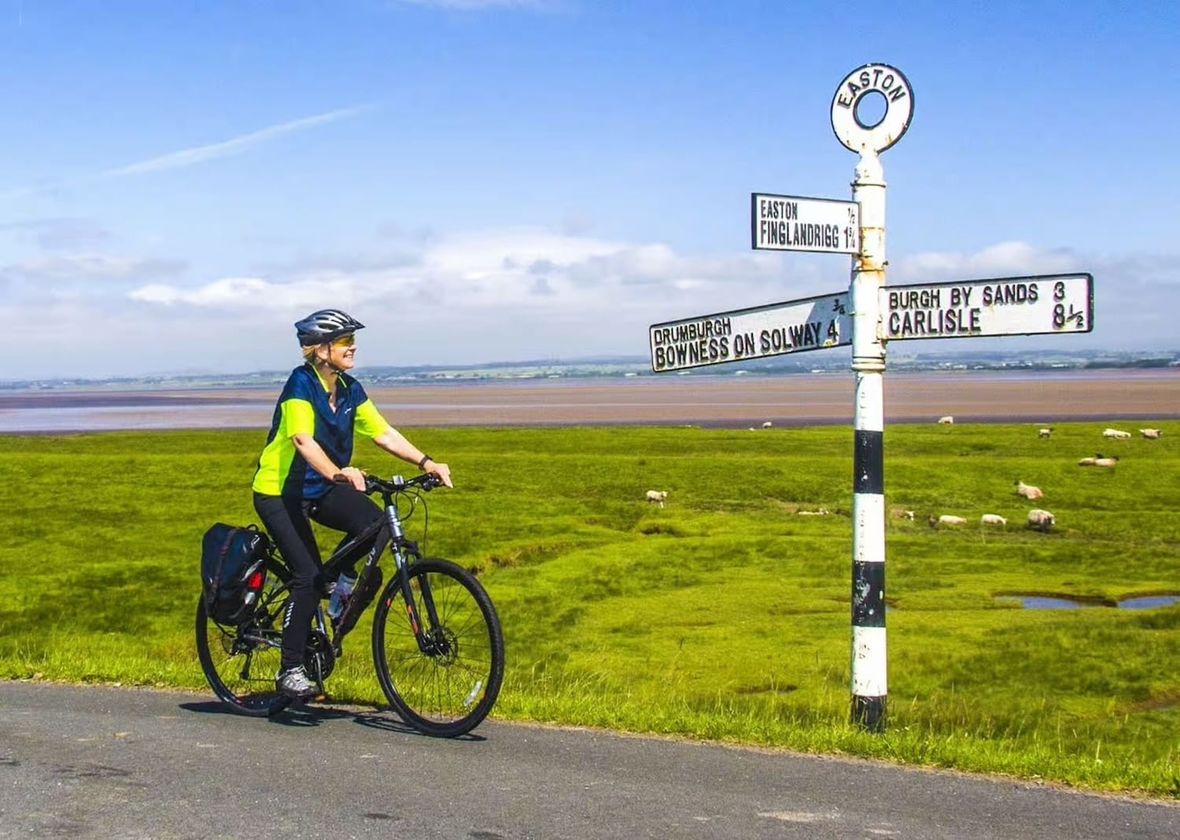 Cyclist by signpost in the UK