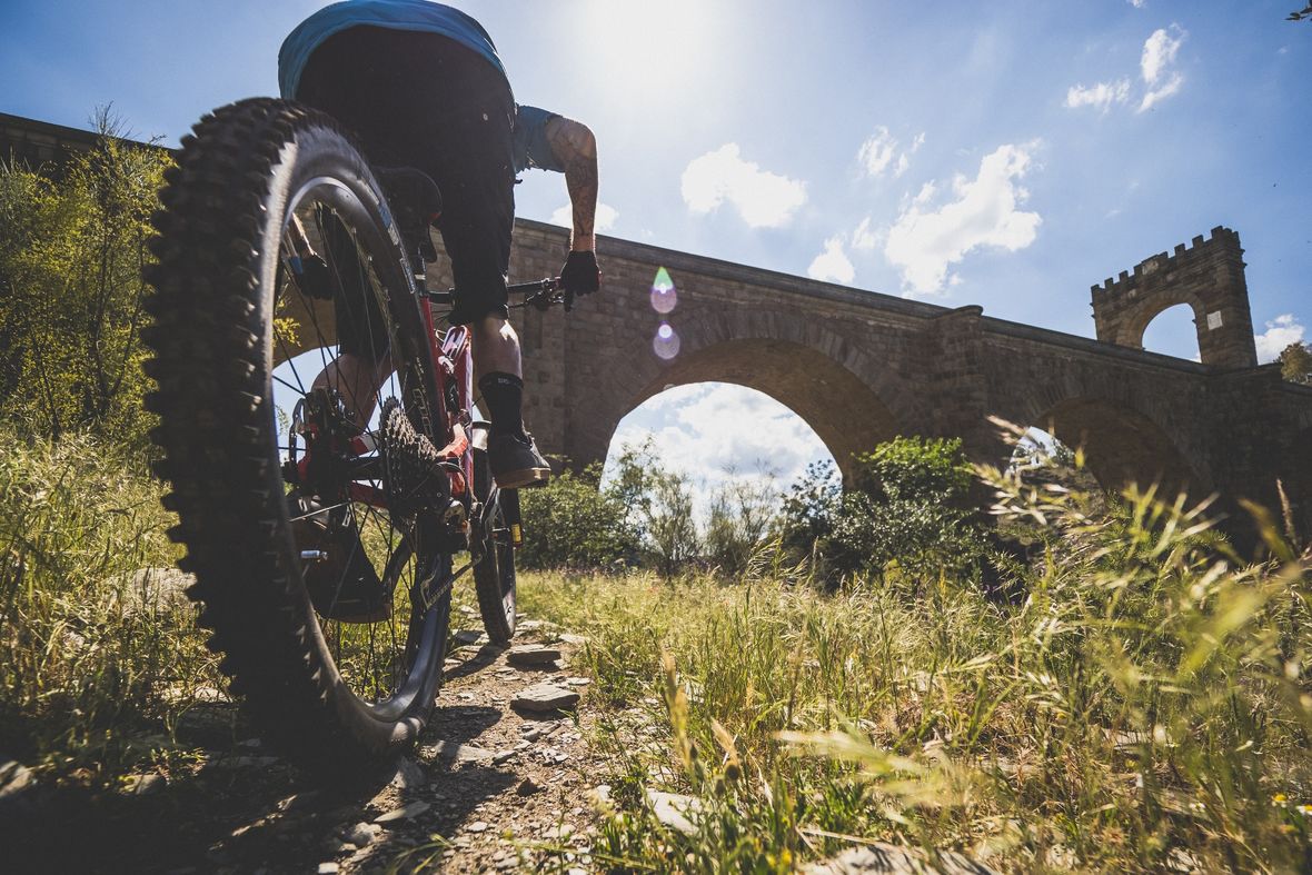 Crossing under the Roman Bridge of Alcántara with the sun in my eye.