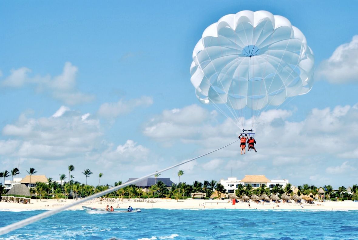 Parasailing over tropical beach and water