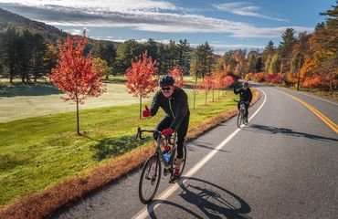  Cyclists riding along road in fall