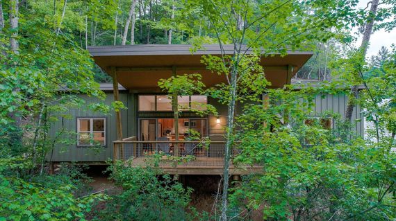 Bordering Pisgah National Forest, the modern cabins at Pilot Cove are designed to blend into their verdant setting and have easy access to area trails