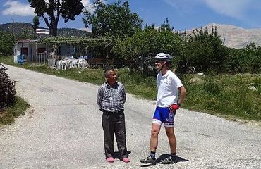 Cyclist talking to local