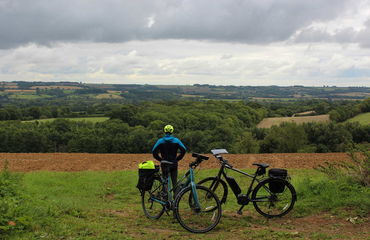 Cyclist looking over rural landscape