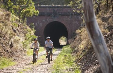 Cyclists riding through a tunnel