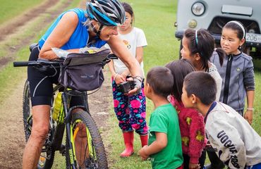 Cyclist talking with children