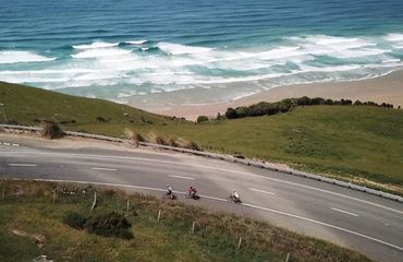 Aerial shot of cyclists on coastal road