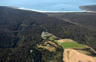 Aerial shot of accommodation resort in bushland by the sea