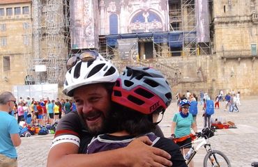 Cyclists hugging in historic city