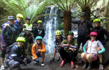 Group of cyclists at waterfalls