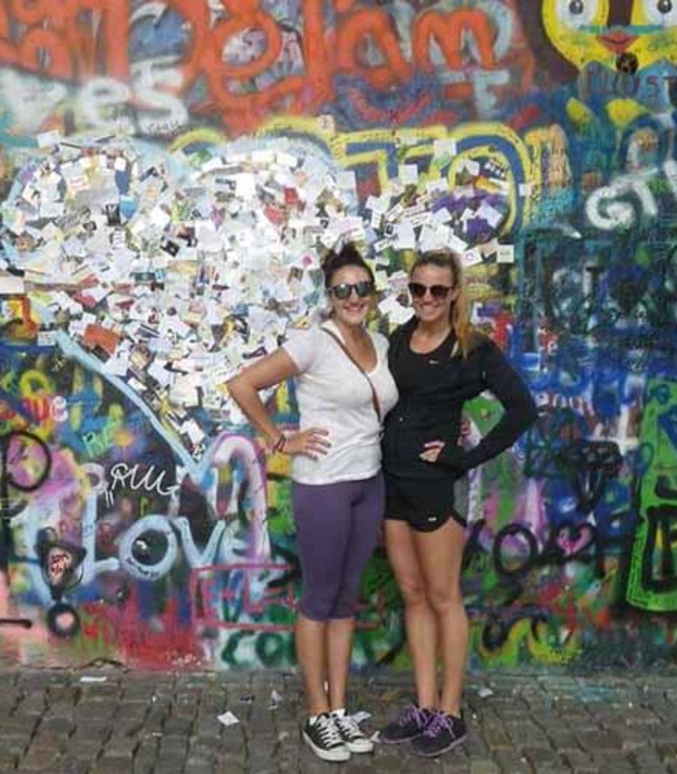 Walk the length of the spectacularly-graffitied Lennon Wall
