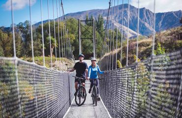 Two cyclists on a bridge