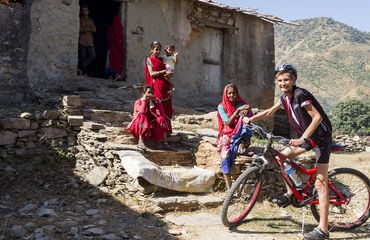 Cyclist with locals sitting on steps