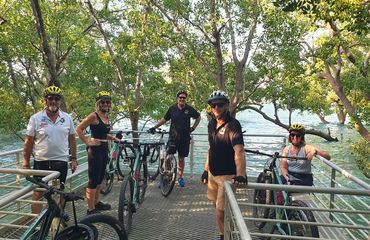 Cyclists at a viewpoint over water