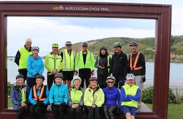 Group of cyclists in giant photo frame