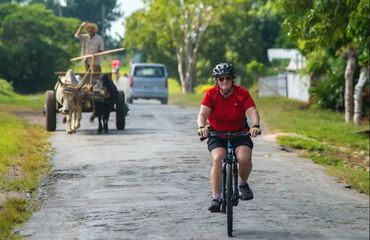 Cyclist riding down rural road
