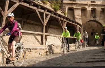 Cyclists riding cobbled streets