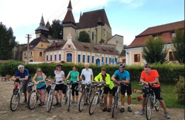 Group of cyclists infront of a church