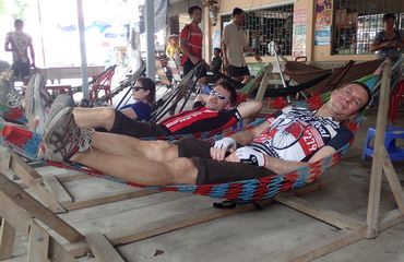 Cyclists resting on hammock