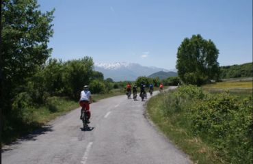 Cyclists riding along a quiet road in countryside