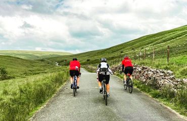 Three cyclists on rural road