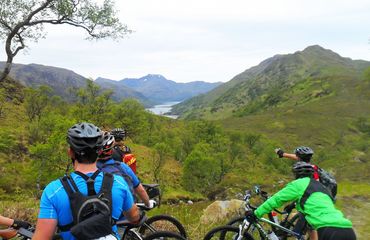 Cycling group looking at view of mountains and water