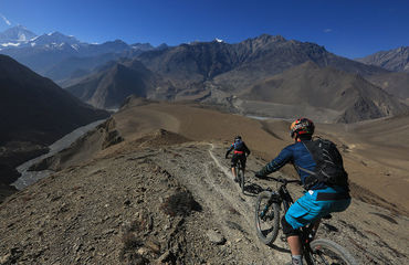 Two cyclists with mountain views