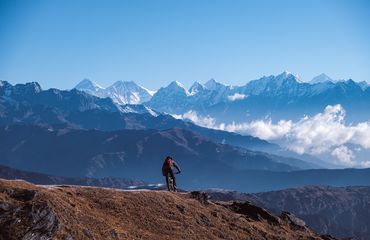 Mountain biker with Himalayas background