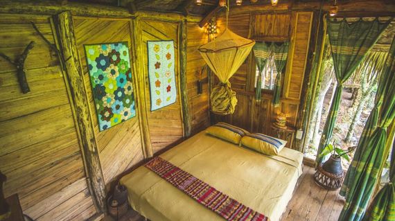 Nestled in the trees high above rice paddies, retreat to this cozy property after a day of activities