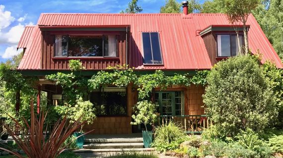 A warm and welcoming timber lodge surrounded by mountains and bordered by Buller River
