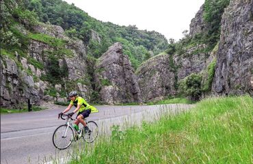 Cyclist riding through gorge roads