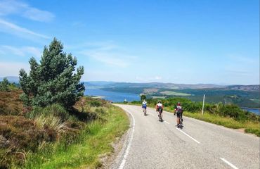 Cyclists on rural road with water views