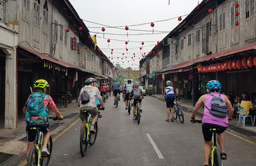 Cyclists riding down town street