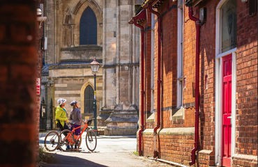 Couple of cyclists looking at church in town