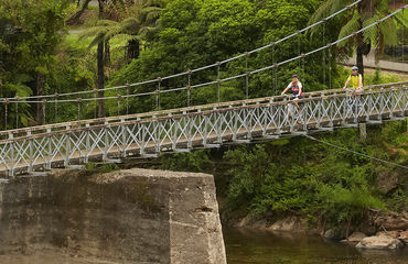 Cyclists riding across a bridge