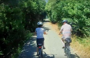 Couple on sheltered rural path on bikes