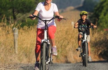 Adult and child on bikes in rural setting