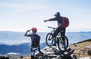 Mountain bikers looking at view and pointing