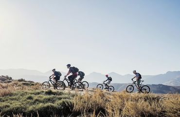 Group of cyclists riding in mountains