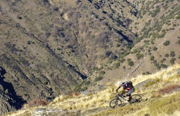 Cyclist riding along a mountain path