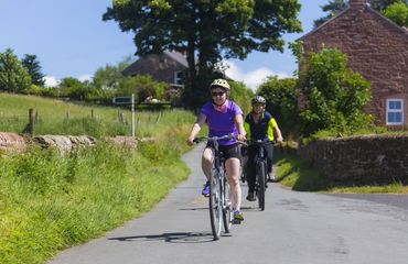 Cyclists riding on rural road