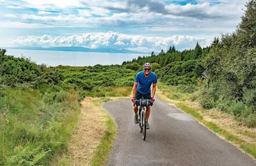 Cyclist riding rural road