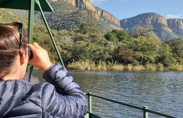 Woman on a boat looking at mountains