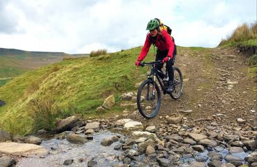 Cyclist on off road track about to cross water