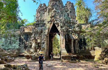 Cyclists riding through Angkor Wat