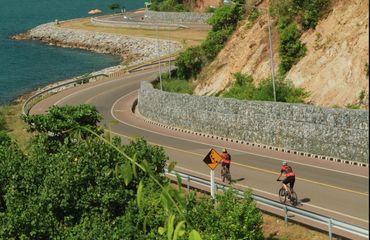 Cyclists riding coastal road