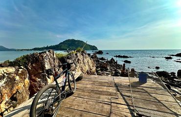 Bike by ocean, leaning on rocks