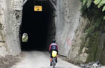 Cyclist riding into a tunnel